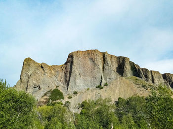 Built structure on rock against sky