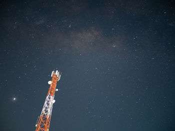 Low angle view of tower against sky at night