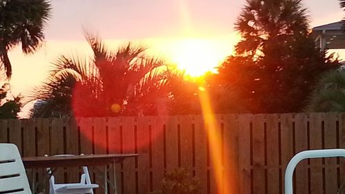 Close-up of chairs at sunset