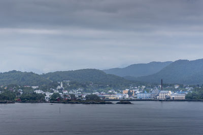 Scenic view of harbor by sea against sky