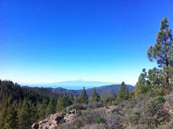 Scenic view of mountains against clear blue sky