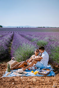 Young couple on field at dusk