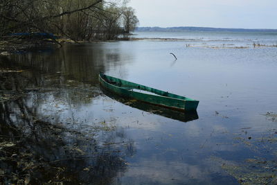Abandoned boat moored in water