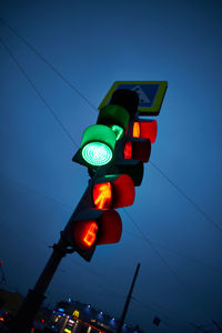 Low angle view of traffic signal against clear blue sky