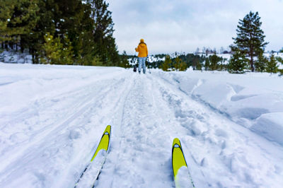 People skiing on snow covered field