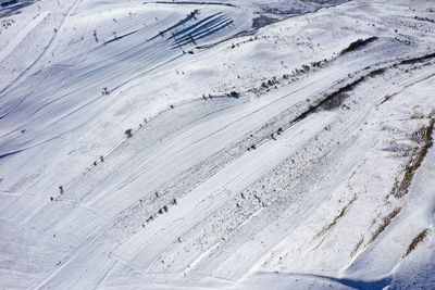 Aerial drone view of snow patterns and background. snow covered countryside terraces mountains