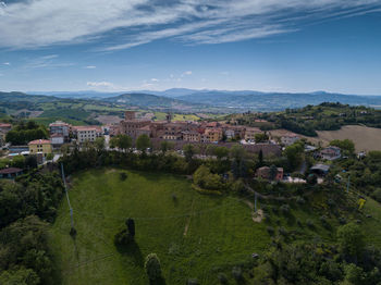 High angle view of houses and buildings against sky