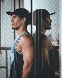 Profile view of thoughtful man standing by window