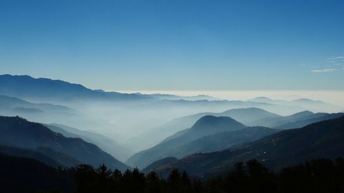 Scenic view of silhouette mountains against sky