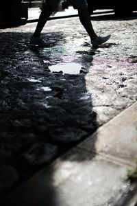 Low section of person walking on street