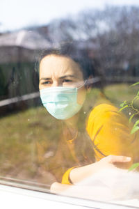 Portrait of woman holding glass with reflection