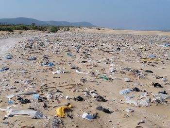 Garbage on beach against clear sky