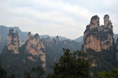 Panoramic view of rocks and trees against sky