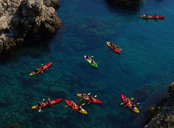 High angle view of people kayaking in sea