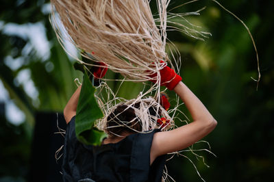 Woman with plants standing outdoors