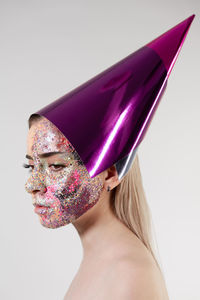 Portrait of woman wearing hat against white background