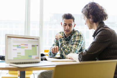 Professor and student talking in classroom