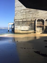 Lifeguard hut on beach against clear sky