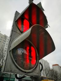 Low angle view of road sign against sky