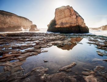 Rocks on beach against sky