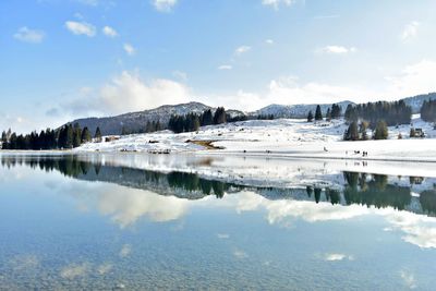 Scenic view of lake against sky during winter
