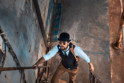 Man holding umbrella standing outdoors