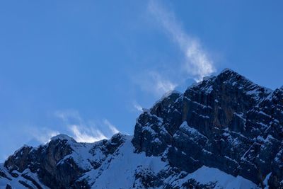 Scenic view of snowcapped mountains against blue sky