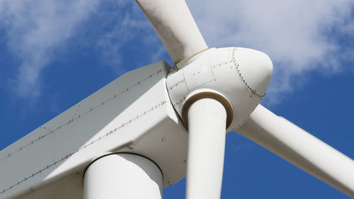 Low angle view of windmill against sky