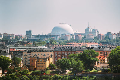 Buildings in city against clear sky