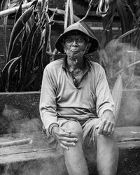 Portrait of young man sitting outdoors