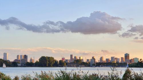 Buildings in city against sky during sunset