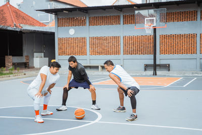 People playing with ball on basketball court