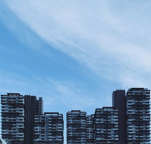 Low angle view of buildings in city against sky