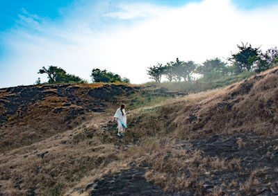 Rear view of man walking on mountain