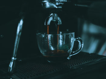 Close-up of coffee pouring in glass