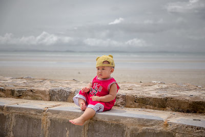 Full length of boy on beach against sky