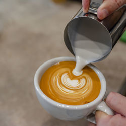 Midsection of woman holding coffee cup