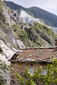 House on mountain against trees and mountains