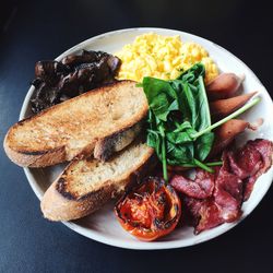 High angle view of meat and breads served in plate