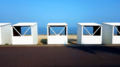 View of beach against clear blue sky