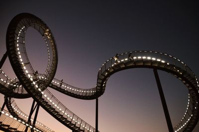 Low angle view of illuminated ferris wheel against sky at night