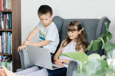 Children study online at home or make a video call through a laptop. communication with friends 