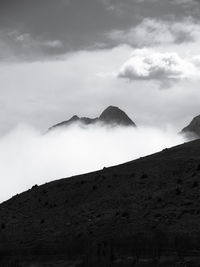 View of mountain range against cloudy sky