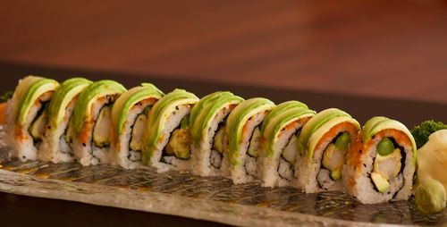 Close-up of avocado and shrimp tempura roll on table