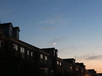 Low angle view of buildings against sky at sunset