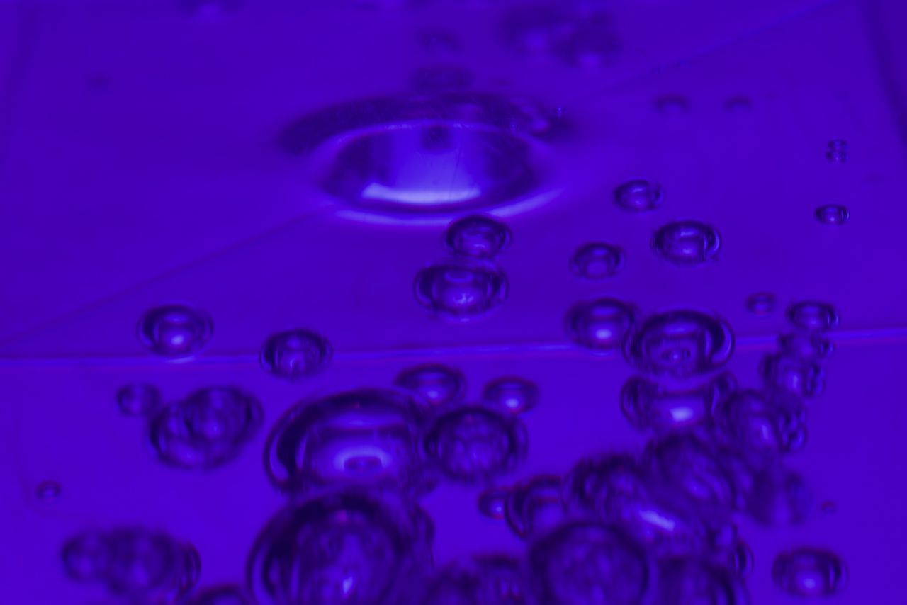 CLOSE-UP OF BUBBLES AGAINST SEA