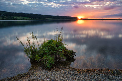 Scenic view of lake against sky during sunset