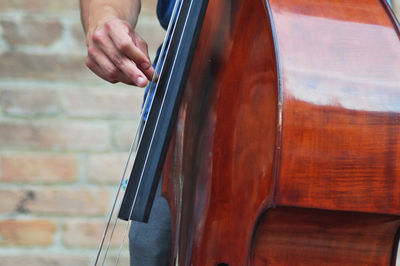 Midsection of person playing cello