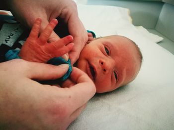 Close-up of baby boy on bed at home