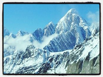 Scenic view of snow covered mountains against sky